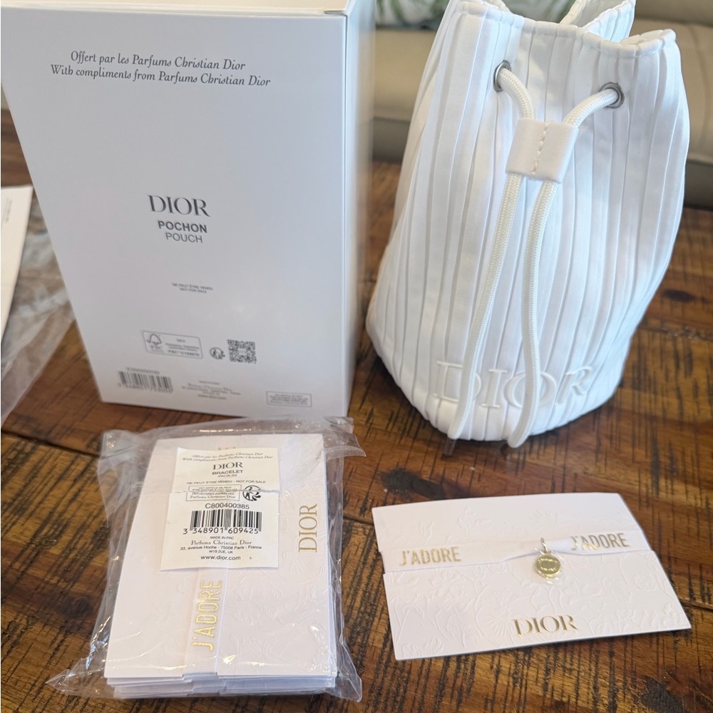 Dior White tall round pouch with white clothe and gold charm bracelet